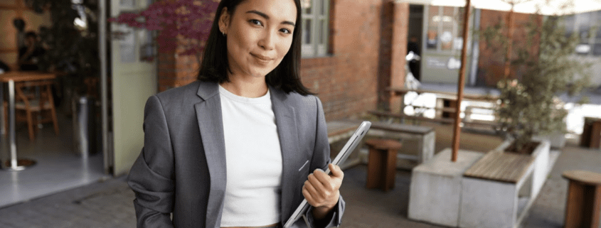 a woman in a business suit holding a tablet